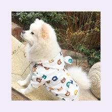 Load image into Gallery viewer, Sitting dog wearing Waterproof Dog Raincoat White color with Bear printing on it
